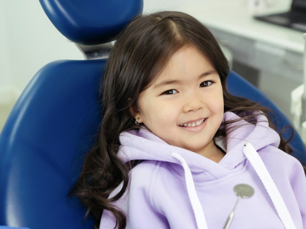 A Smiling Child on a Dental Chair
