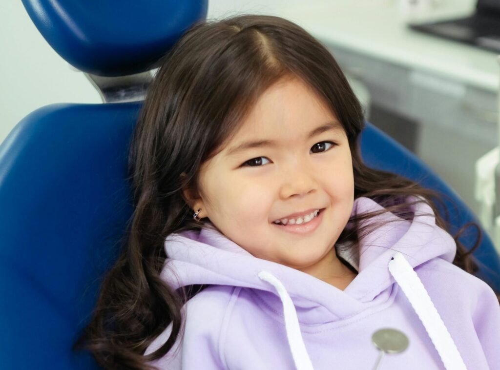 A Smiling Child on a Dental Chair